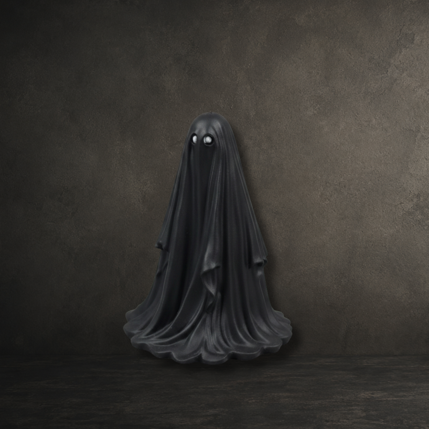 Hand painted black resin ghost with silver eyes, perfect for gothic home décor and spooky ghost collections.