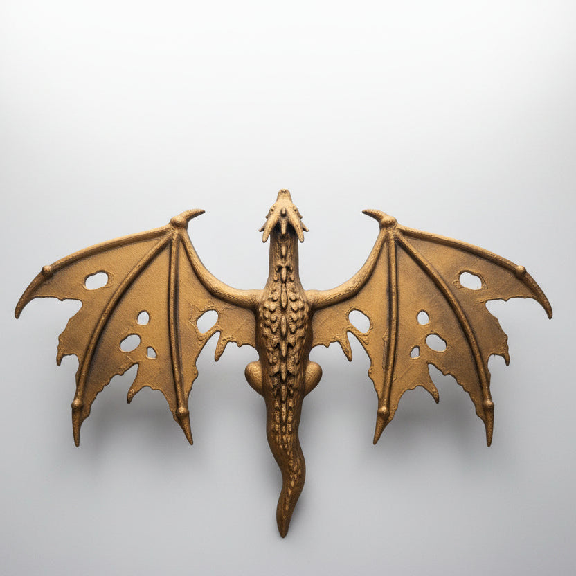 Hand painted bronze dragon spine hugger displayed between fantasy novels as gothic bookshelf decor for book lovers.