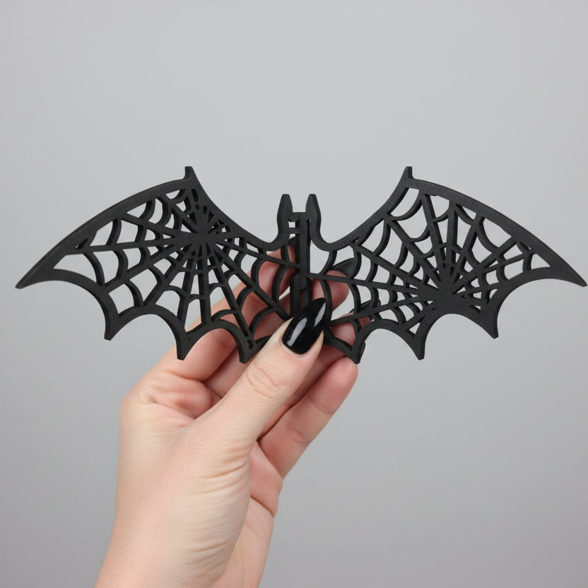 Halloween bat wall decor featuring detailed spiderweb wings