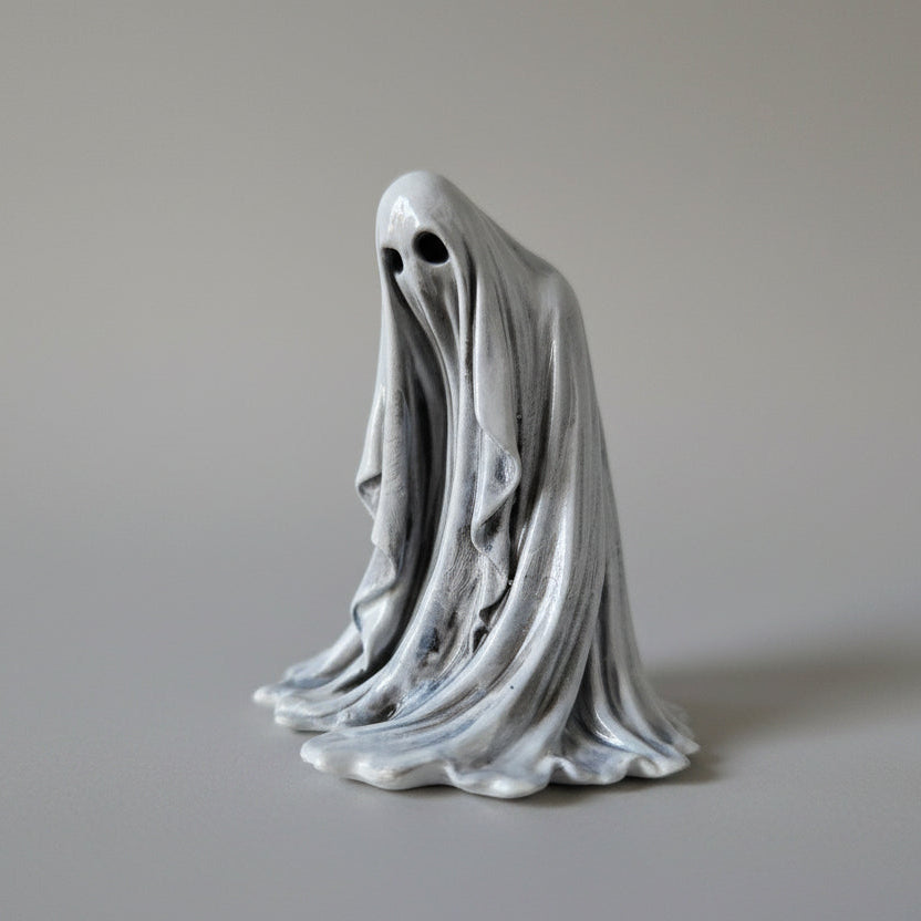 Close up of The Watcher ghost figurine highlighting eye detail and textured folds