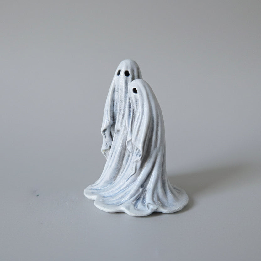 Close up detail of Twin Spirits ghost figurine showing sculpted folds and faces