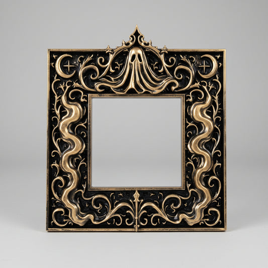 Hand-painted gold gothic ghost light switch surround with flowing veil details and ornate baroque-inspired edges, displayed against a dark background for a dramatic antique finish.