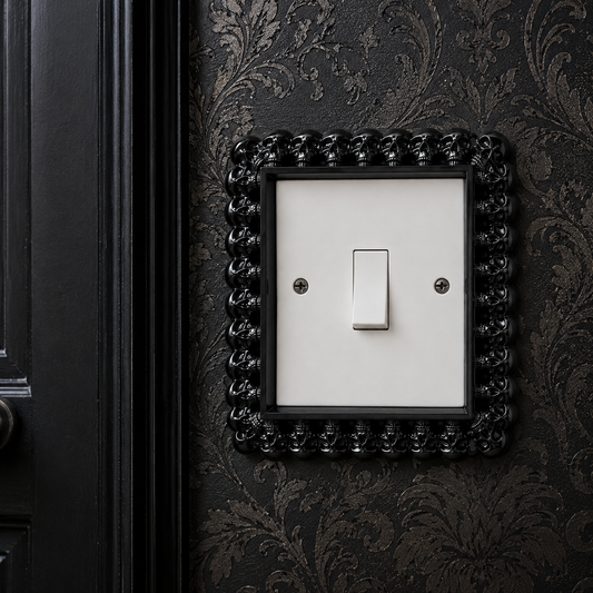 Black resin gothic light switch surround for a standard UK single light switch, featuring an ornate decorative frame with a durable hand-cast resin finish, perfect for gothic, Victorian and dark home décor.