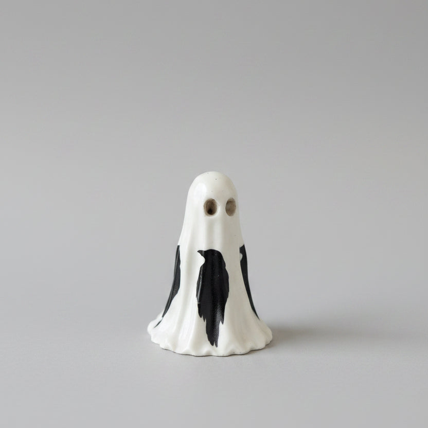 Side view of gothic resin ghost featuring raven decal markings and heavy gloss varnish