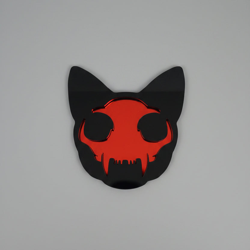 Cat skull pocket mirror made from black acrylic with a red mirrored acrylic centre.