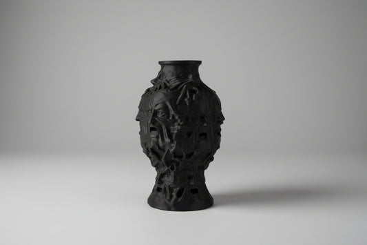 Dark gothic vase with multiple faces decor