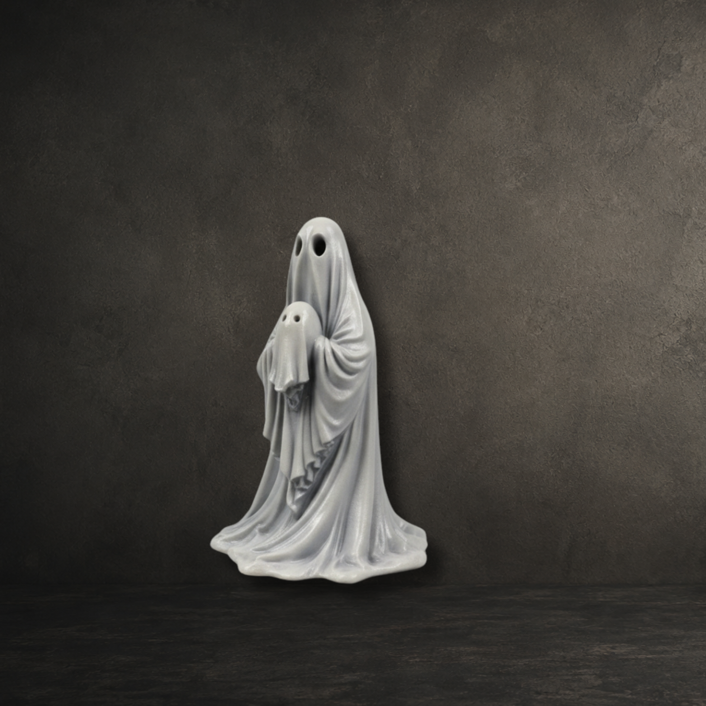Hand painted resin ghost gently holding a little ghost baby, perfect for gothic home décor and ghost collections.