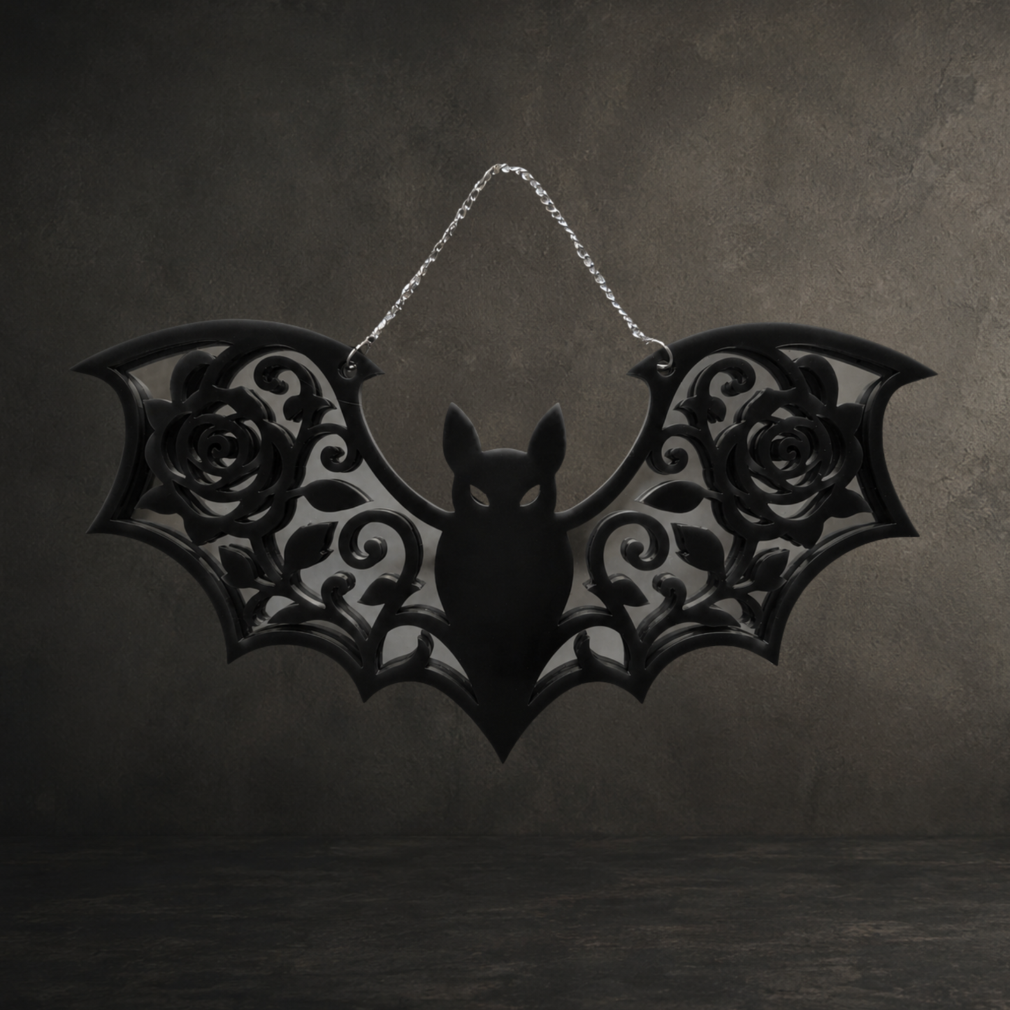 Black gothic bat acrylic mirror with ornate rose wing design and hanging chain, 250mm wide.