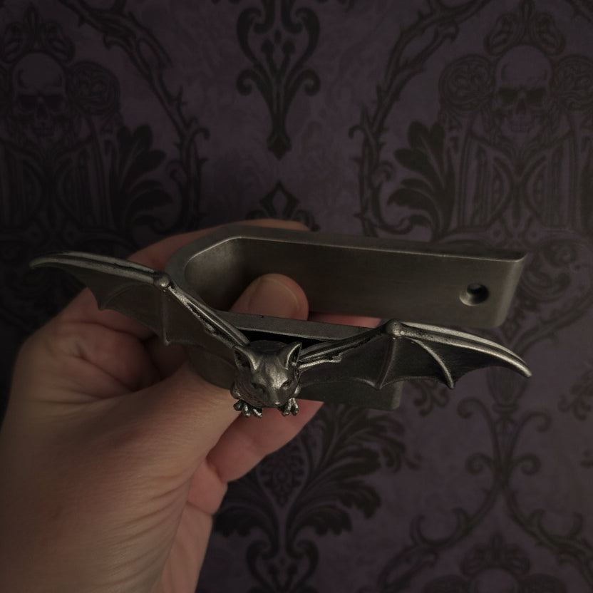 Gothic bat curtain tie back holder, hand-cast in durable resin with a detailed bat design and winged hook, perfect for holding curtains open in gothic, Victorian, Halloween and dark academia interiors.