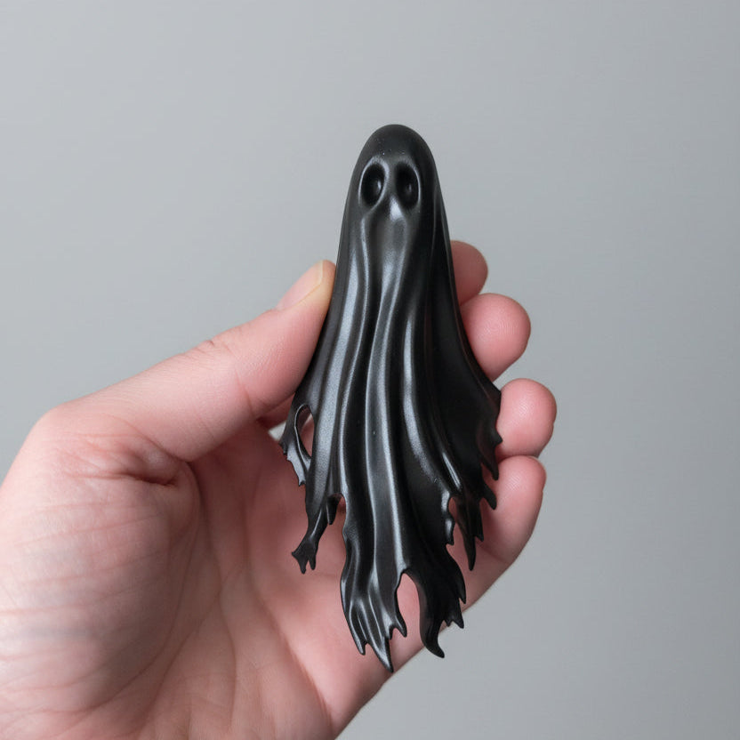 Haunting resin ghost spine hugger for gothic bookshelves and spooky reading spaces