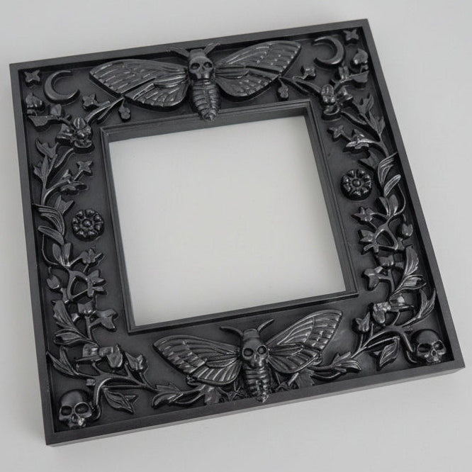Close up of Death’s Head Moth light switch surround showing textured wings, skull detail and gothic black finish.