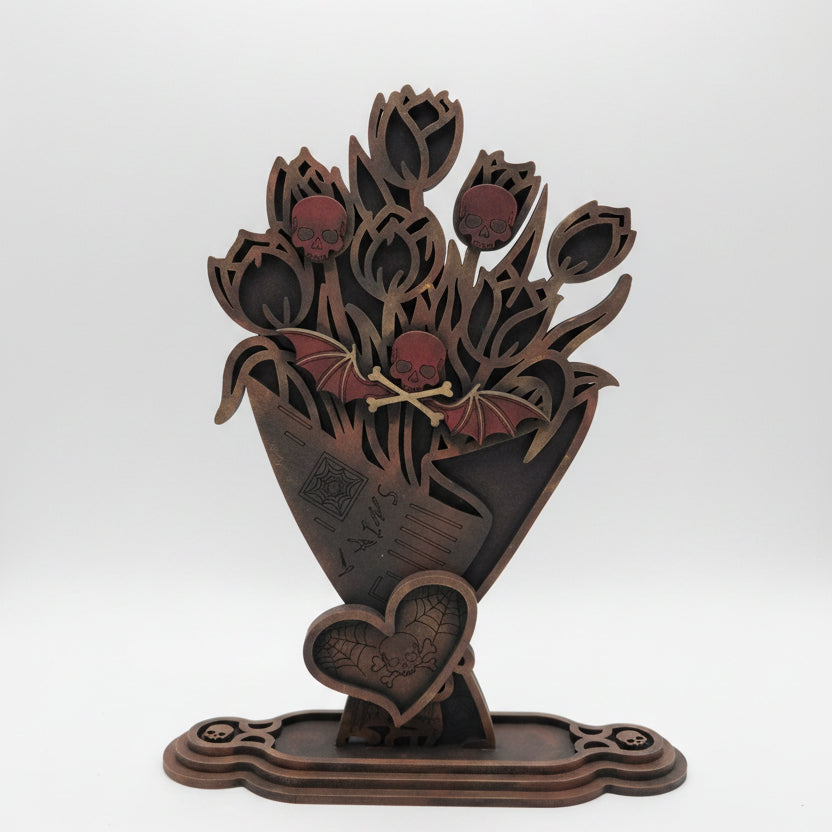 Hand painted wooden gothic skull bouquet with bat and spiderweb details displayed as spooky home decor