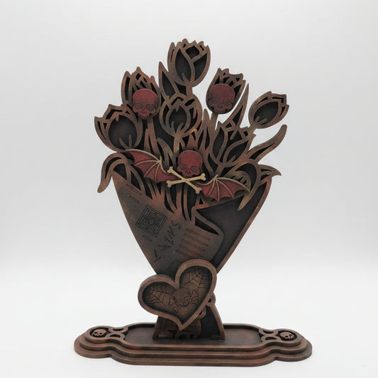 Hand painted wooden gothic skull bouquet with bat and spiderweb details displayed as spooky home decor
