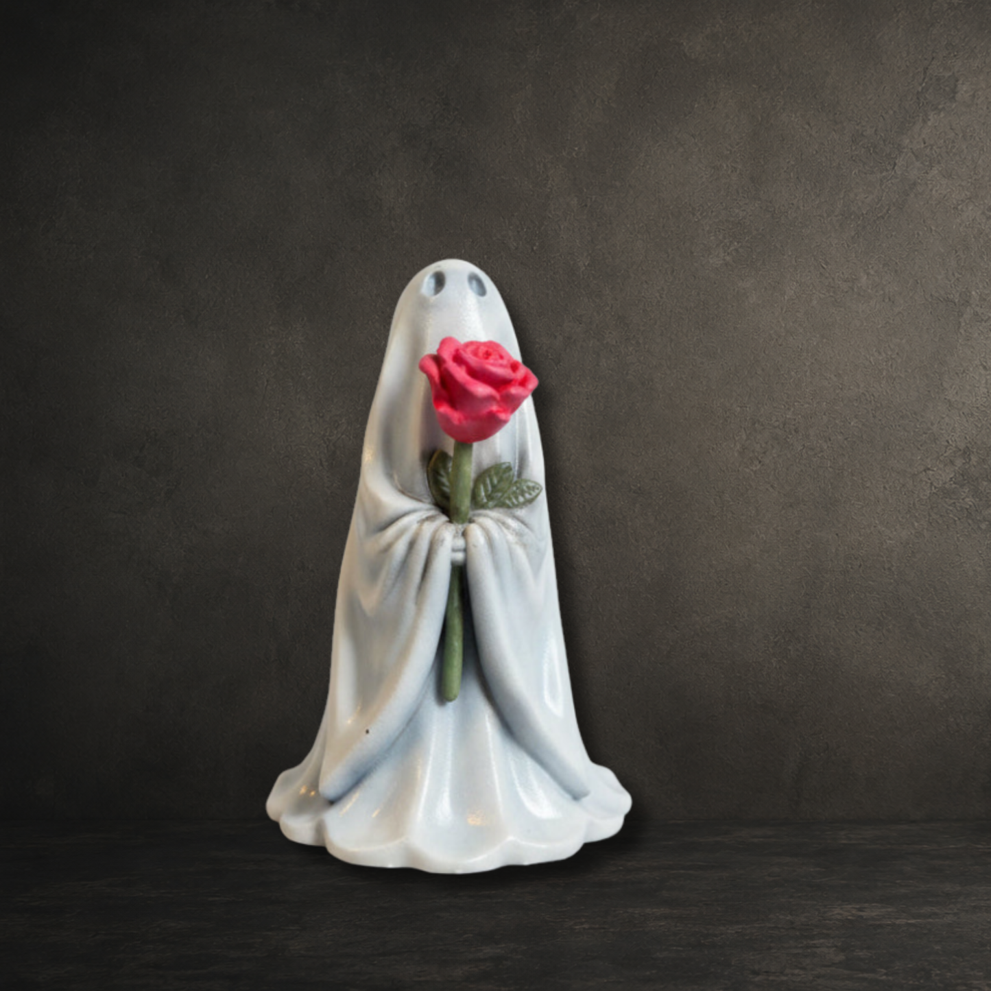 Small gothic ghost figurine with a pink flower for home décor