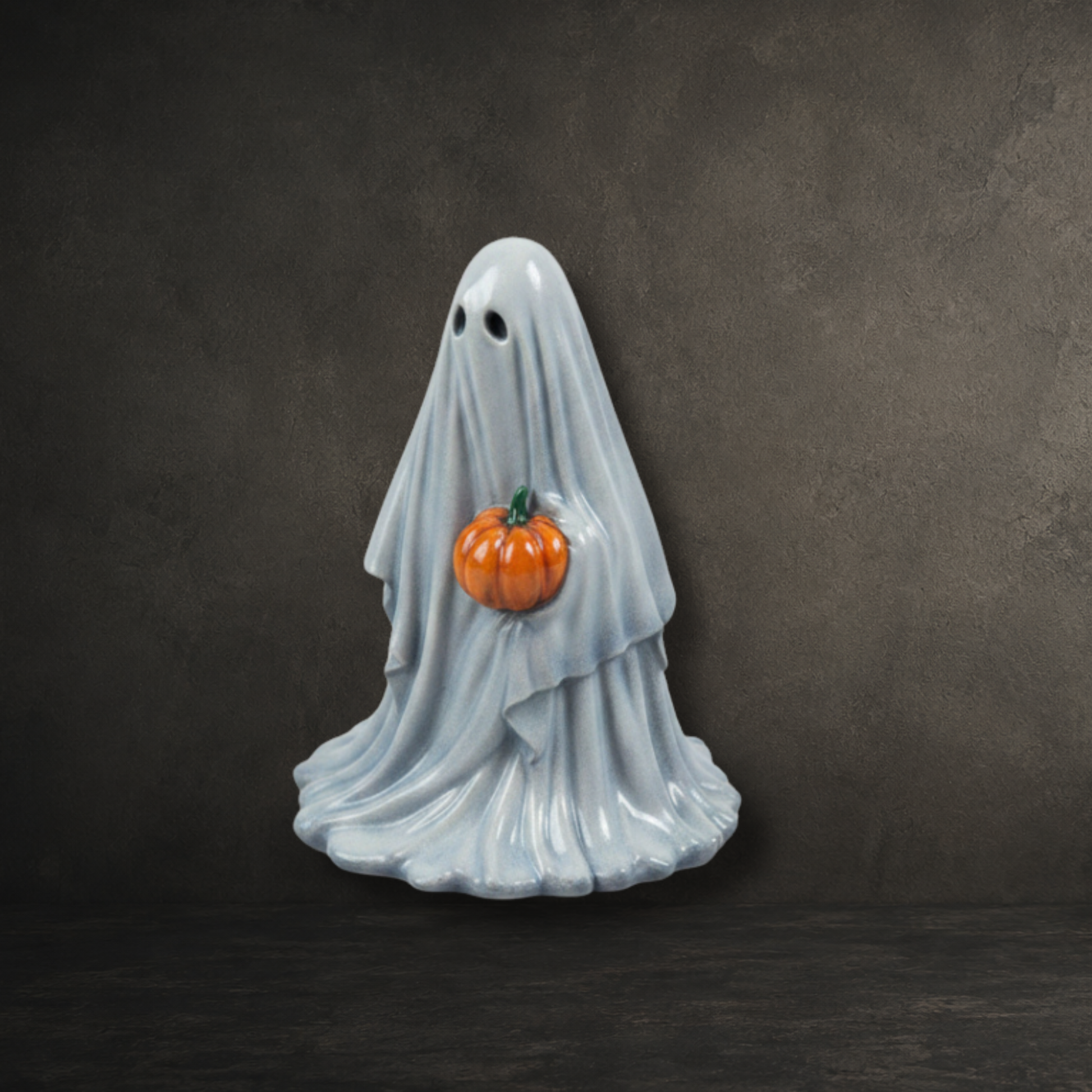 Hand painted resin ghost carrying a carved pumpkin, perfect for Halloween décor and gothic ghost collections.