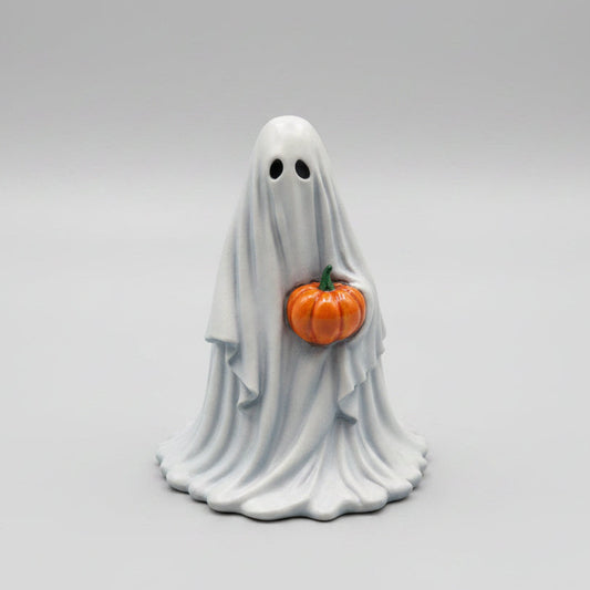 Hand painted Pumpkinbearer ghost figurine holding orange pumpkin front view