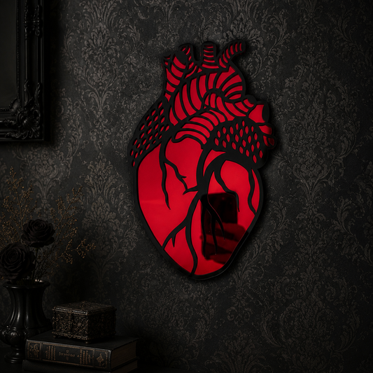 Red acrylic anatomical heart mirror featuring detailed gothic-inspired artwork, perfect for alternative home decor, gallery walls, and dark interiors.