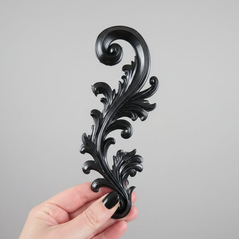 Decorative resin filigree scroll suitable for wall mounting or furniture embellishment, featuring intricate gothic baroque detailing.
