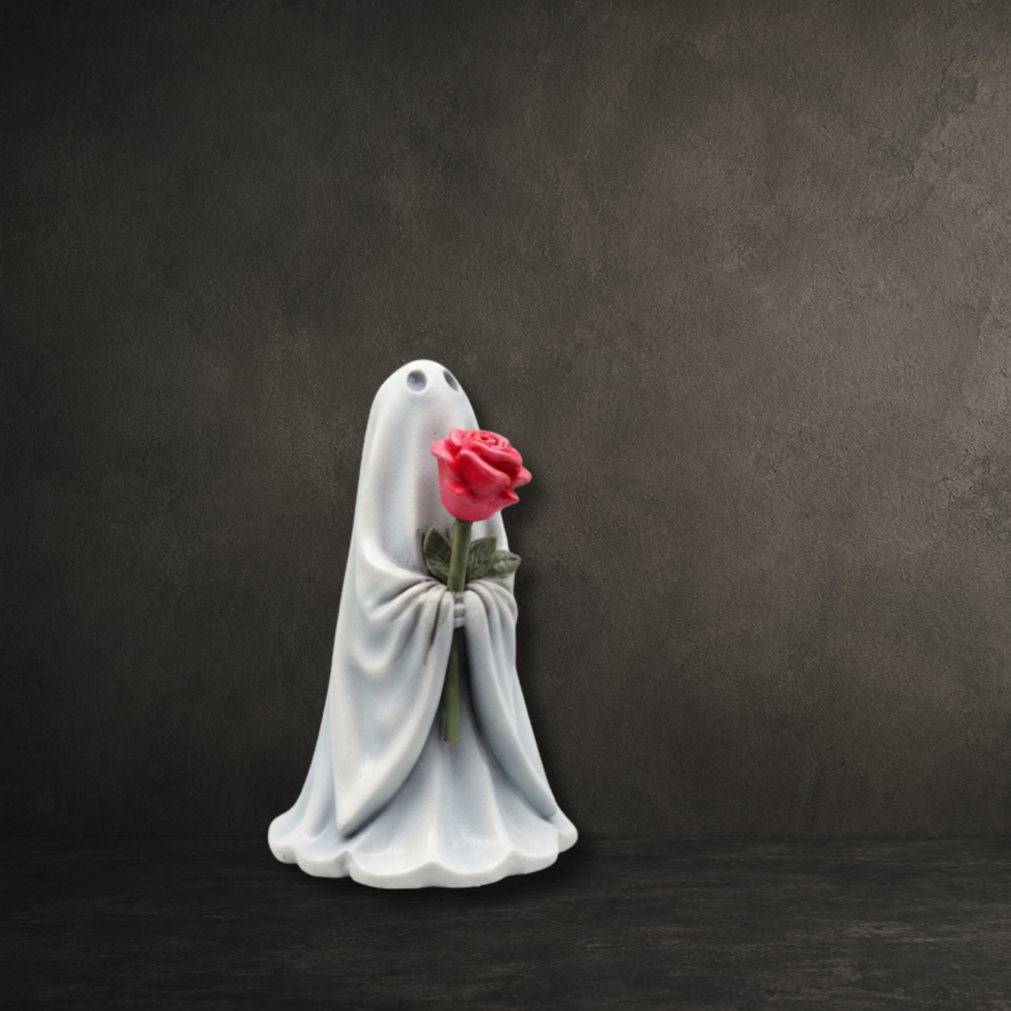 Hand-painted resin lady ghost ornament carrying a delicate pink rose