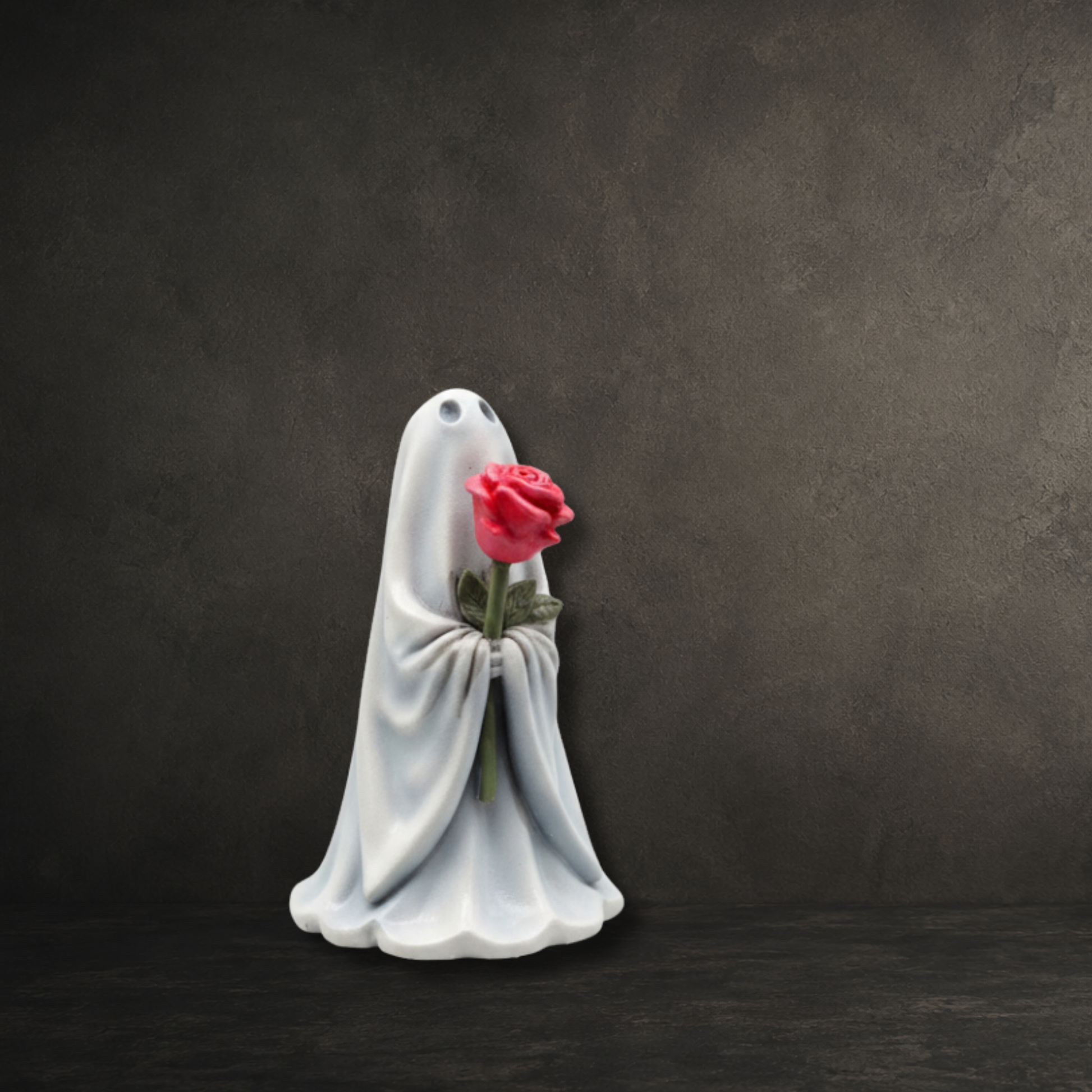 Hand-painted resin lady ghost ornament carrying a delicate pink rose