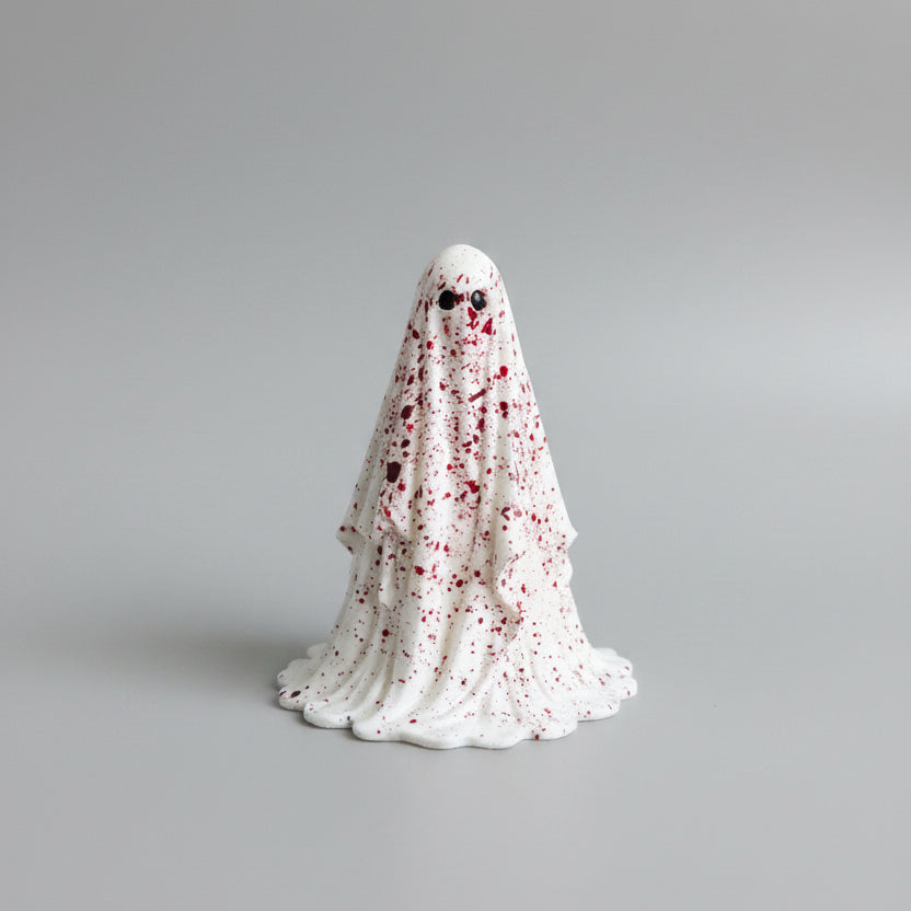 Horror inspired ghost collectible with dramatic crimson detailing and dark hollow eyes