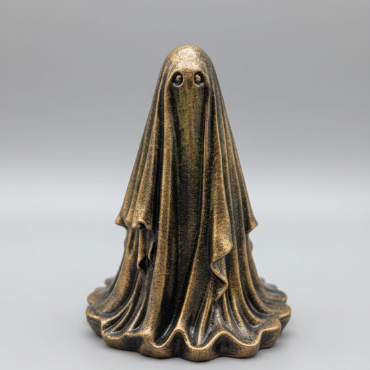 Close-up of The Gilded Wraith ghost figurine with antique gold finish and dark recessed details