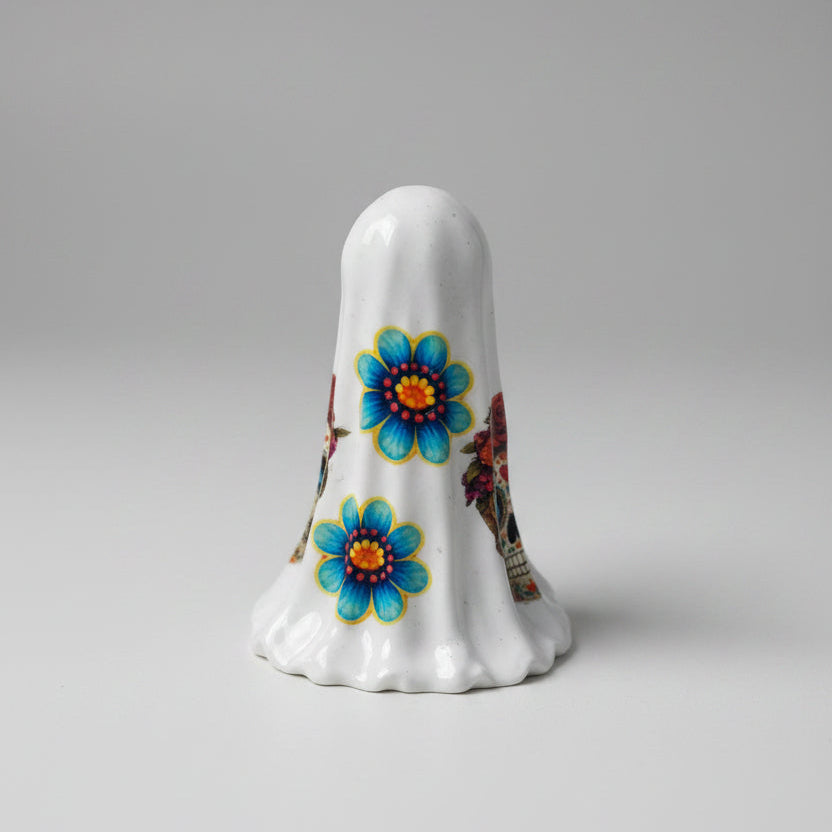 Side view of The Marigold Spirit ghost figurine with vibrant floral Day of the Dead design