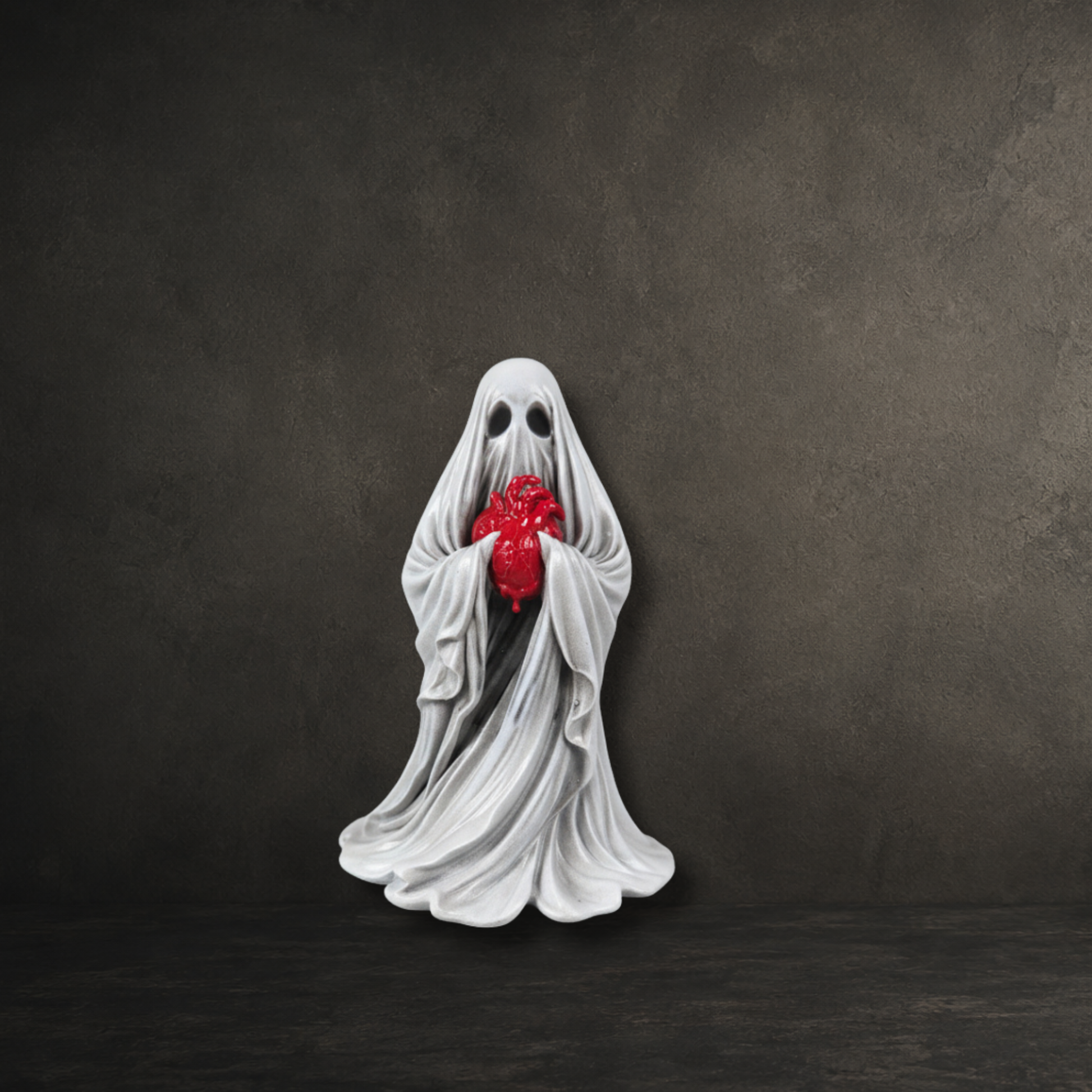 The Reliquary Ghost hand painted 6cm resin ghost holding an anatomical heart by Darkmoon Designs.