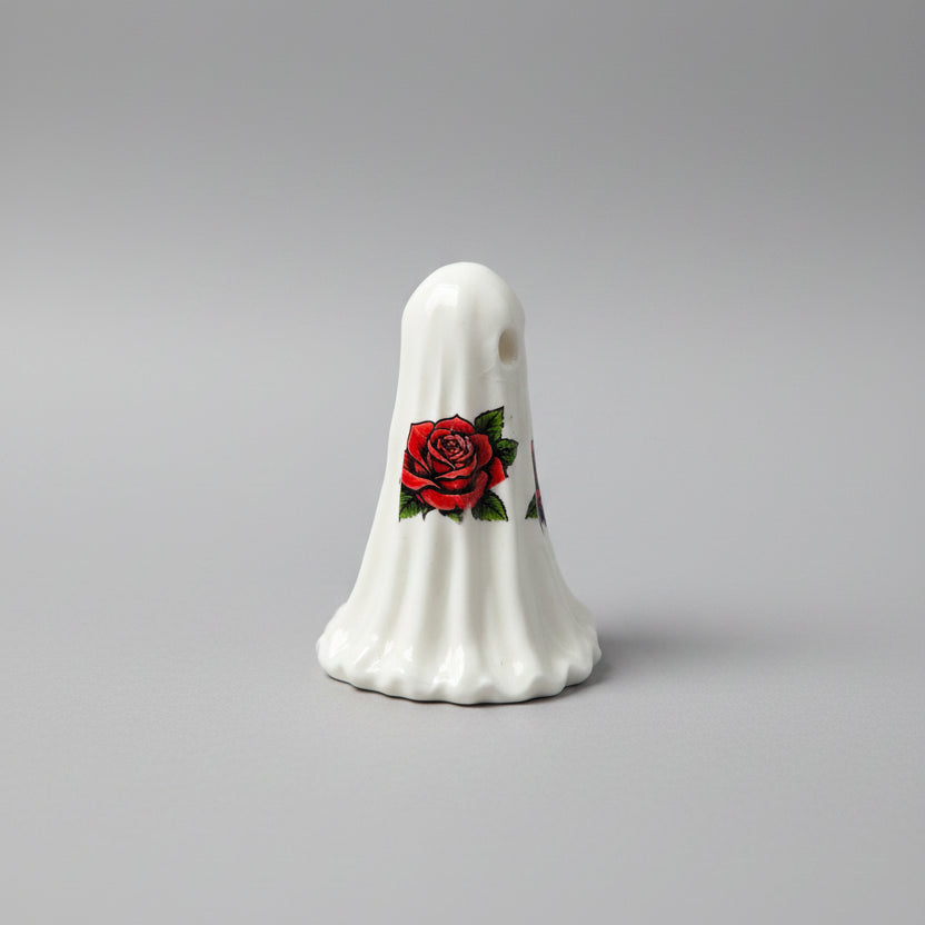 Close-up detail of red rose decals on The Rosebound Haunt resin ghost collectible