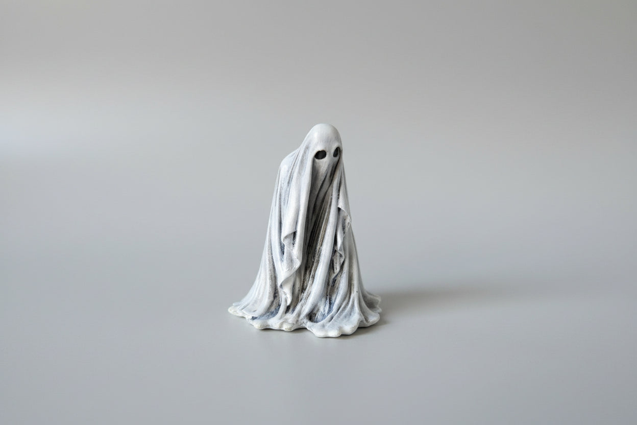 Side view of The Watcher miniature ghost figurine showing layered folds and silhouette