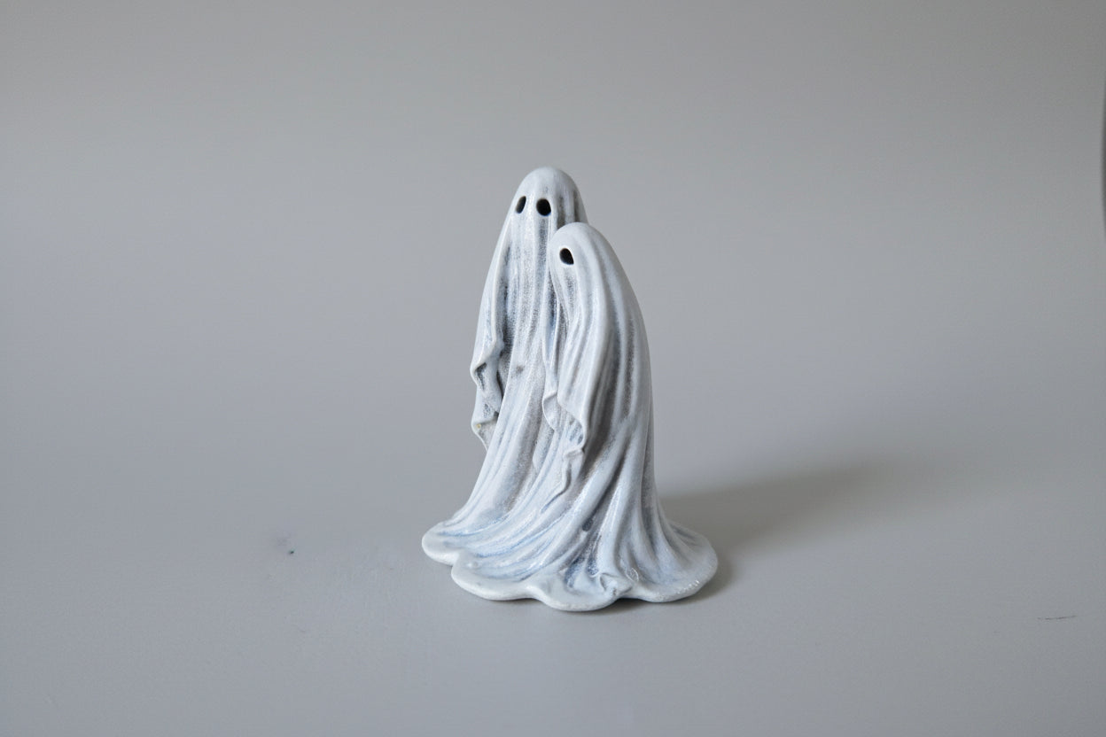Close up detail of Twin Spirits ghost figurine showing sculpted folds and faces